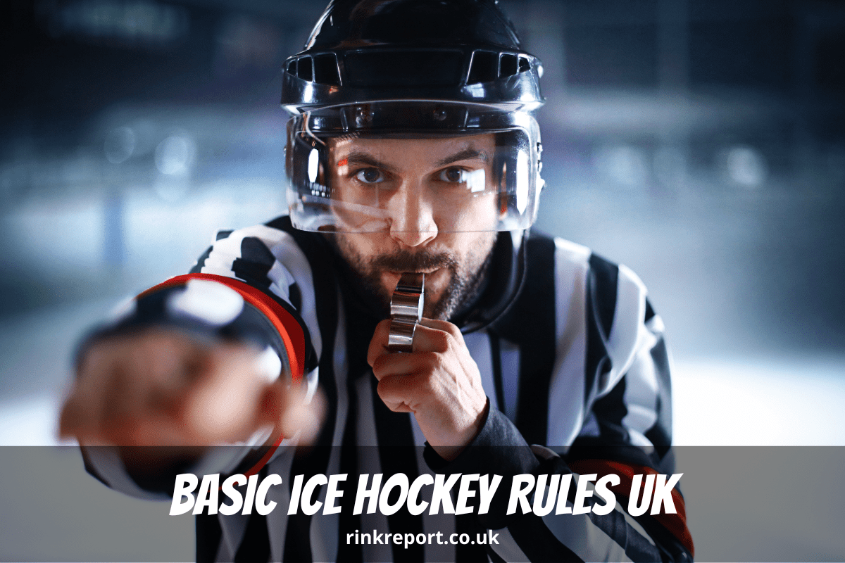 A close up of a referee blowing his whistle to enforce ice hockey rules during a game